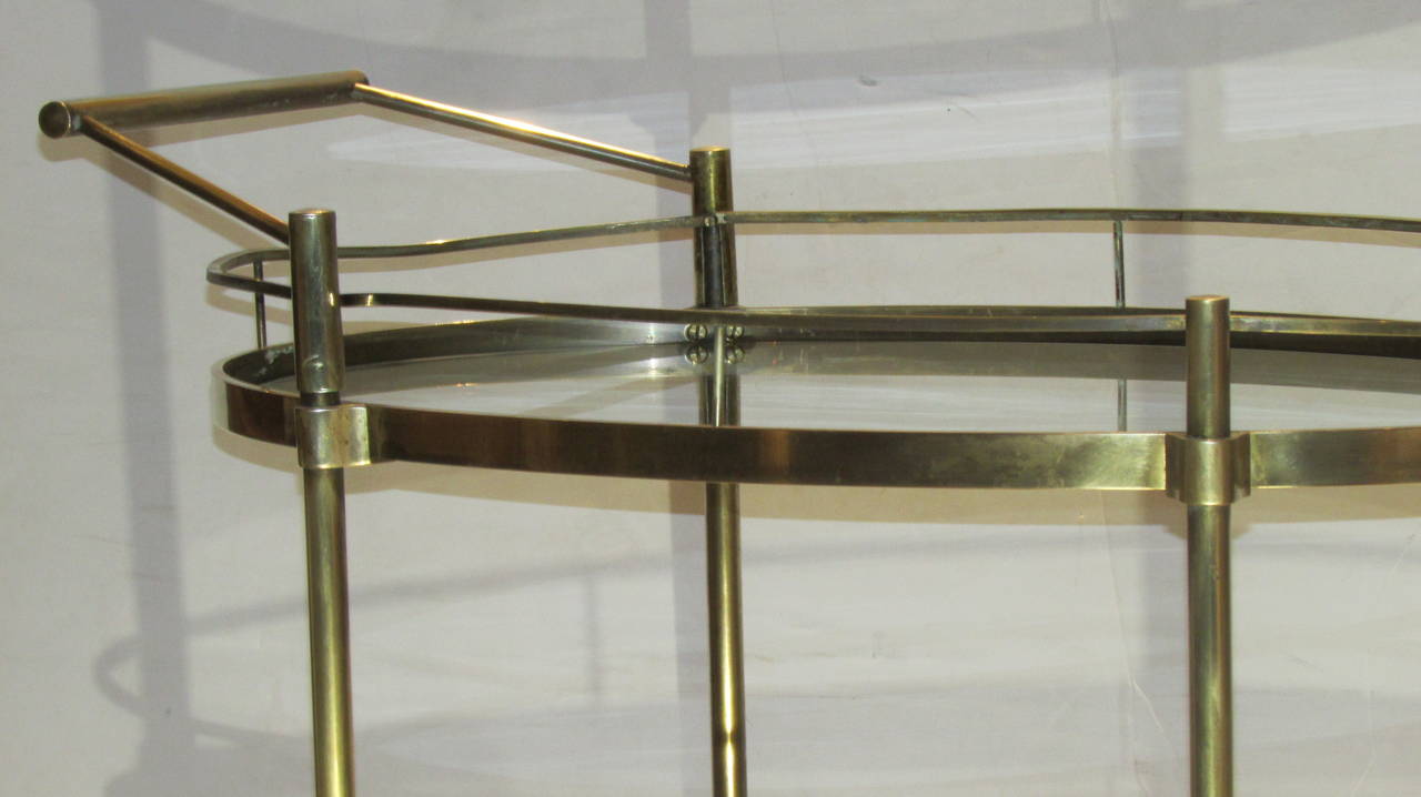 A good quality 1960's Italian brass oval shaped two tier rolling bar cart server with a sleek modernist design.