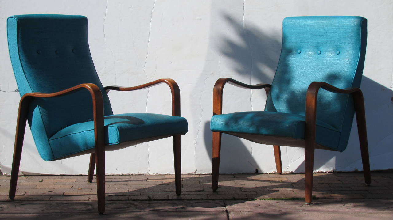 A pair of mid-20th century Thonet bentwood high backed lounge chairs with a beautiful angled & tapered streamlined form - circa 1950s