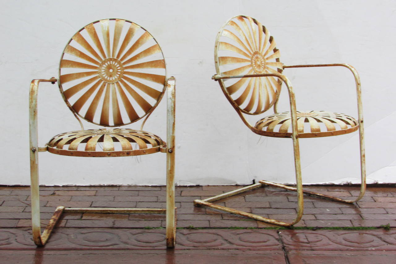 Three matching pinwheel sunburst design cantilever form sprung steel armchairs by Francois Carre, circa 1930. Two with aged old white painted rusted surface and one nice older white paint with no rust. All structurally perfect solid and very