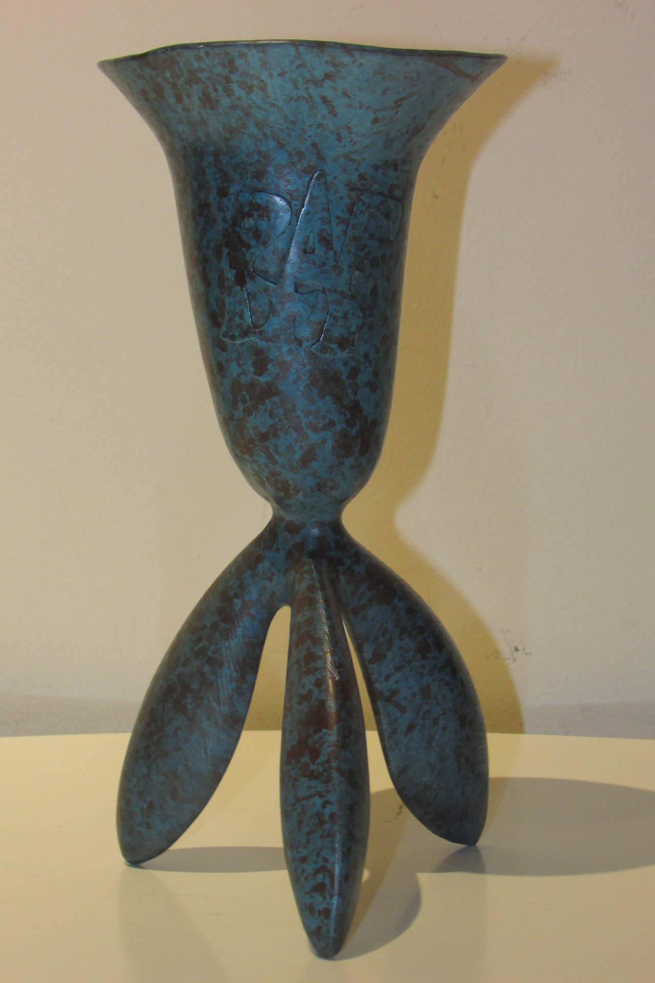 An original turquoise speckled verdigris patinated bronze presentation vessel by Wendell Castle - signed W.C. 94' - with raised letters RAF on one side of trumpet shaped upper body of vase.