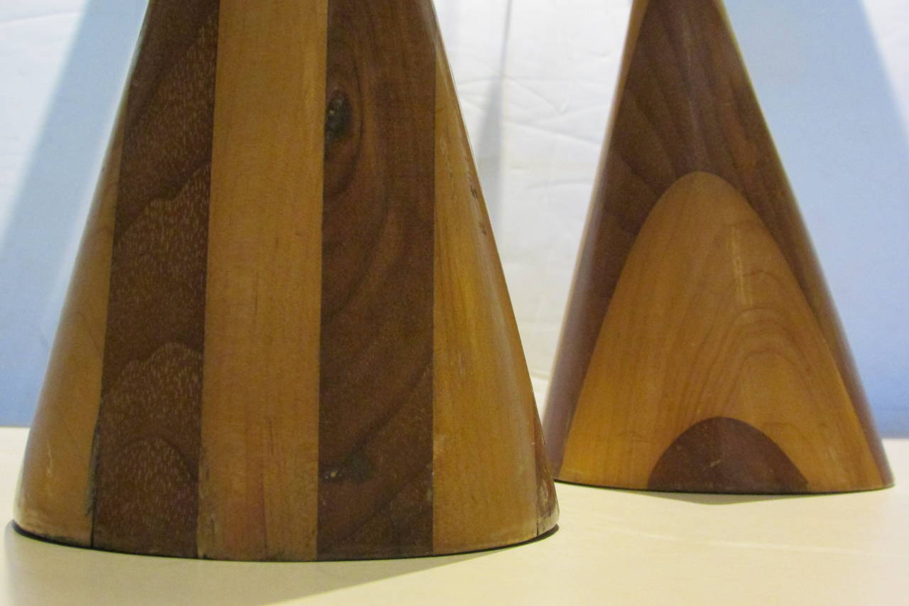 A pair of mid-20th century modernist finely turned two tone inlaid wooden cone forms of very graphic design. A terrific desktop item for the architect.