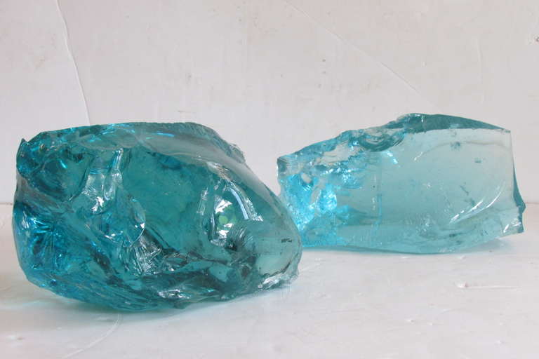 A group of four hard to find large size brilliant transparent chunk glass rocks /  cullet glass. They measure from largest 17