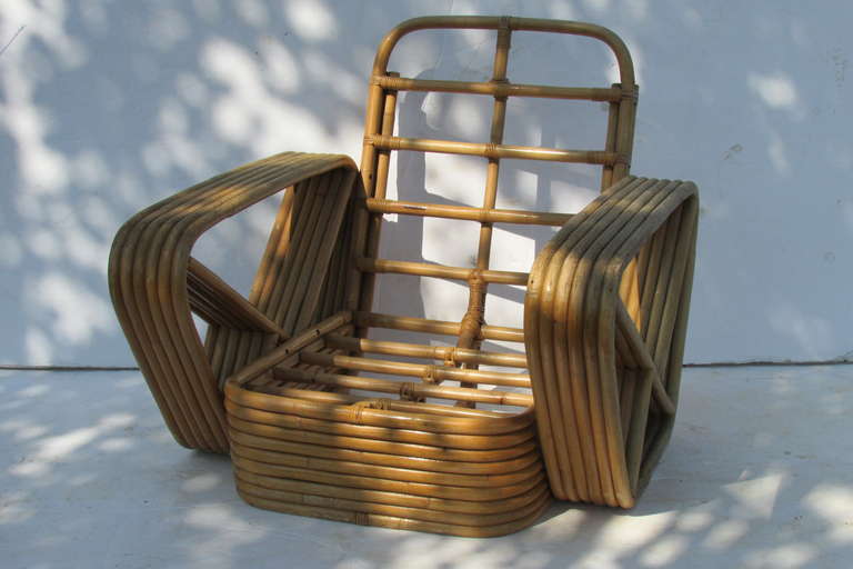 A large six band arm natural rattan lounge chair with nine band rattan base, designed by Paul Frankl. Made in Japan, 1940s.