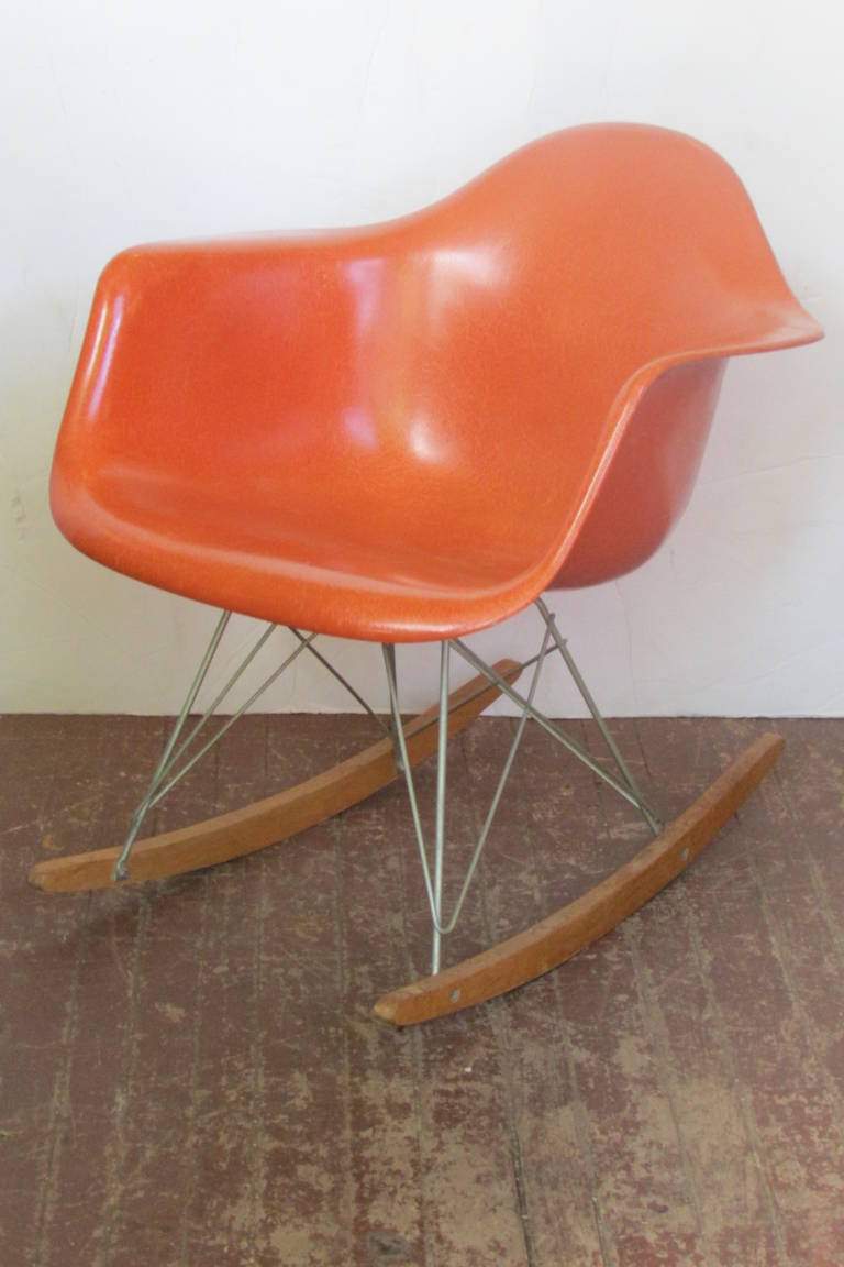 Charles & Ray Eames RAR rocker in all original condition. The red orange fiberglass shell having well exposed fiber content. Retains paper label / Herman Miller logo / ink stamping  / Summit mark.