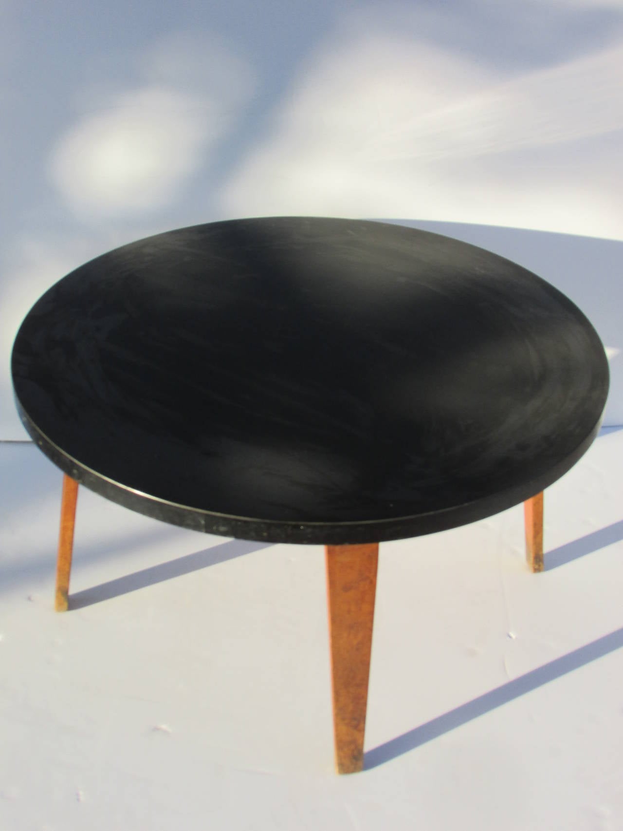 An all original vintage Thonet bentwood coffee / occasional table measuring 16 inches high with a 30 inch diameter round black bakelite  type laminate top - circa 1940s.
