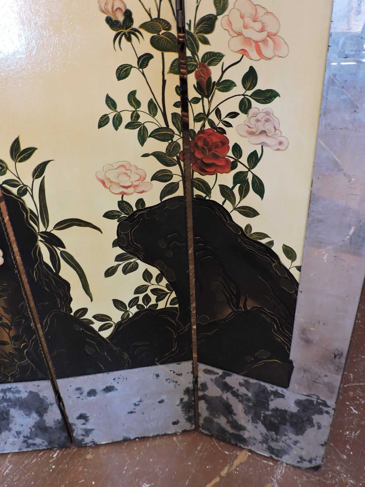 A masterfully hand painted and beautifully oxidized smoked mirror framed six panel folding floor screen with exotic birds and flowers in landscape on a vellum colored field with exceptionally fine detailing and extraordinarily rich colors. In the