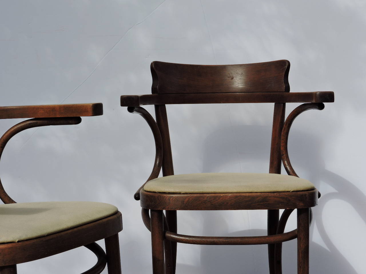 A matched set of four Thonet Bentwood cafe armchairs in the style of Mundus. All chairs in original nicely aged surface color. Thonet paper label under seat.  Circa 1920 - 1940