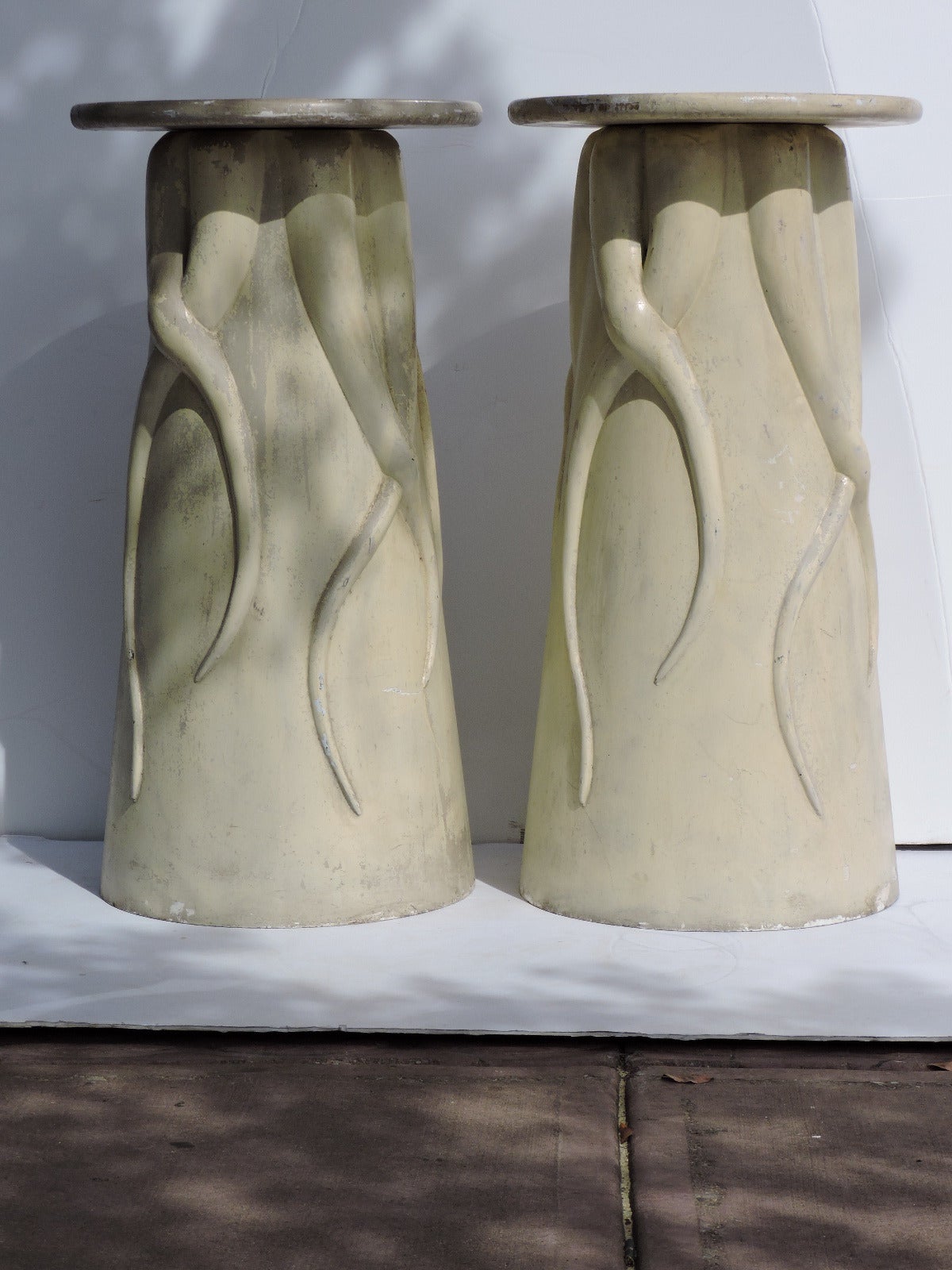 Exotic looking pair of cream white painted tall organic pod form fiberglass pedestals with sinuous octopus like tendrils in relief.