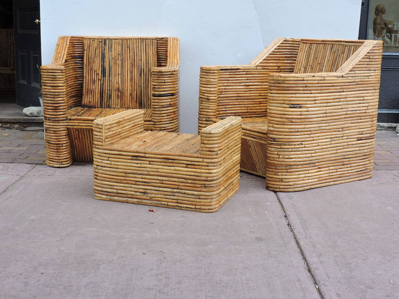 Dating from the 1970s - a spectacular large scale seven piece fully wrapped natural bamboo rattan set in the art deco style with perfectly aged glowing surface and rich variegated honey color to the rattan. The set consists of a sofa - 78" wide