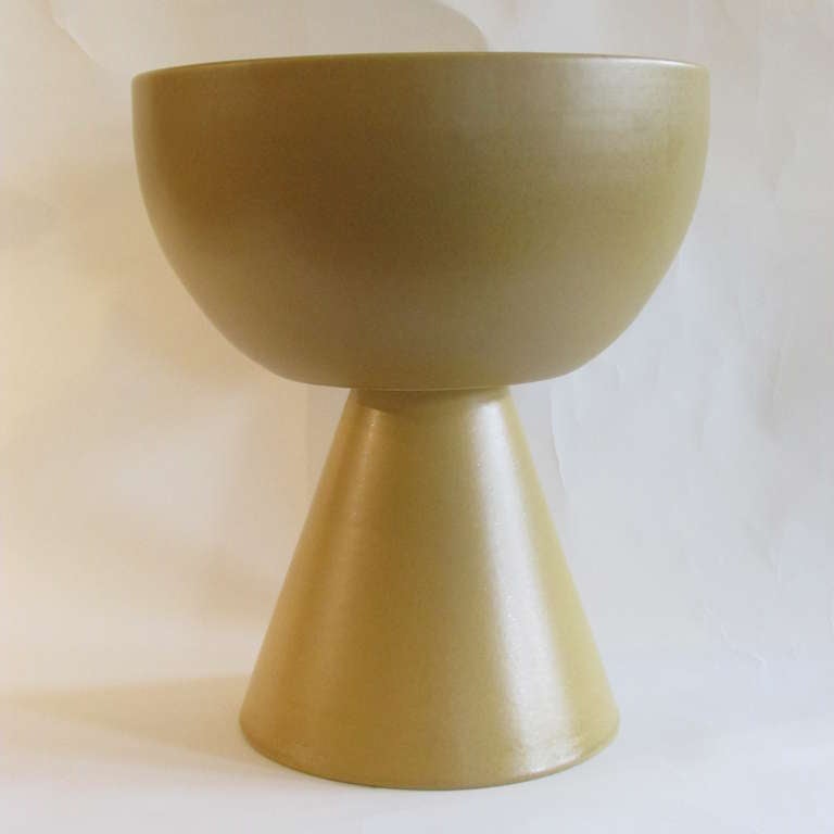Signed with impressed manufacturers mark at bottom interior of bowl - Architectural Pottery Made In U.S.A. - period mid 20th century modernist pedestal planter in a soft gold satin glaze - a very hard to find form - John Follis - circa 1950.