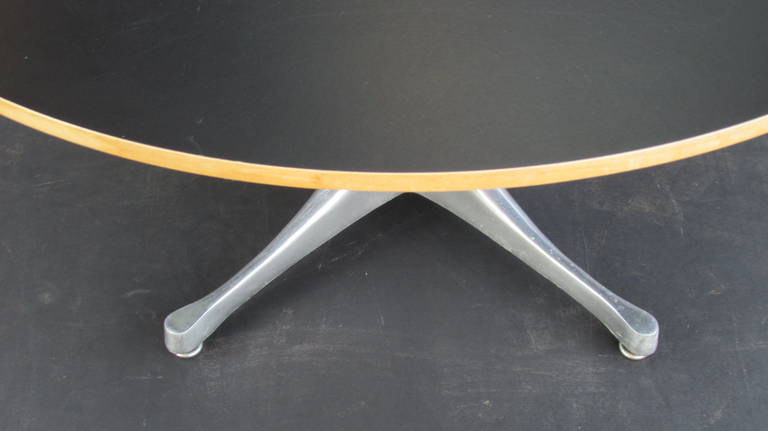 George Nelson for Herman Miller coffee table or side table with polished aluminum sculptural swag leg pedestal base and black laminate top with golden maple veneer edge, circa 1960.