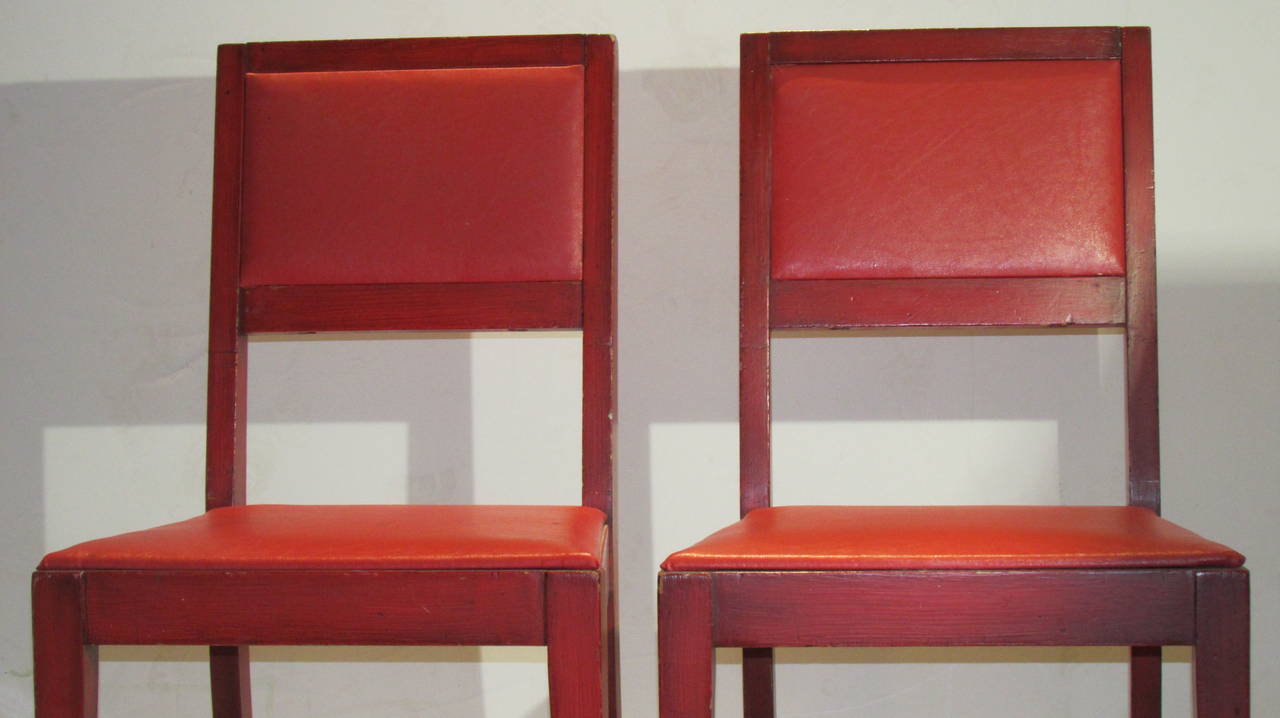 A pair of 1940s modernist chairs in the style of Jean-Michel Frank with original brilliant old Chinese red stained grain painted finish and red oil cloth upholstered seats and backs with overall beautifully aged color and patina. Retailed by