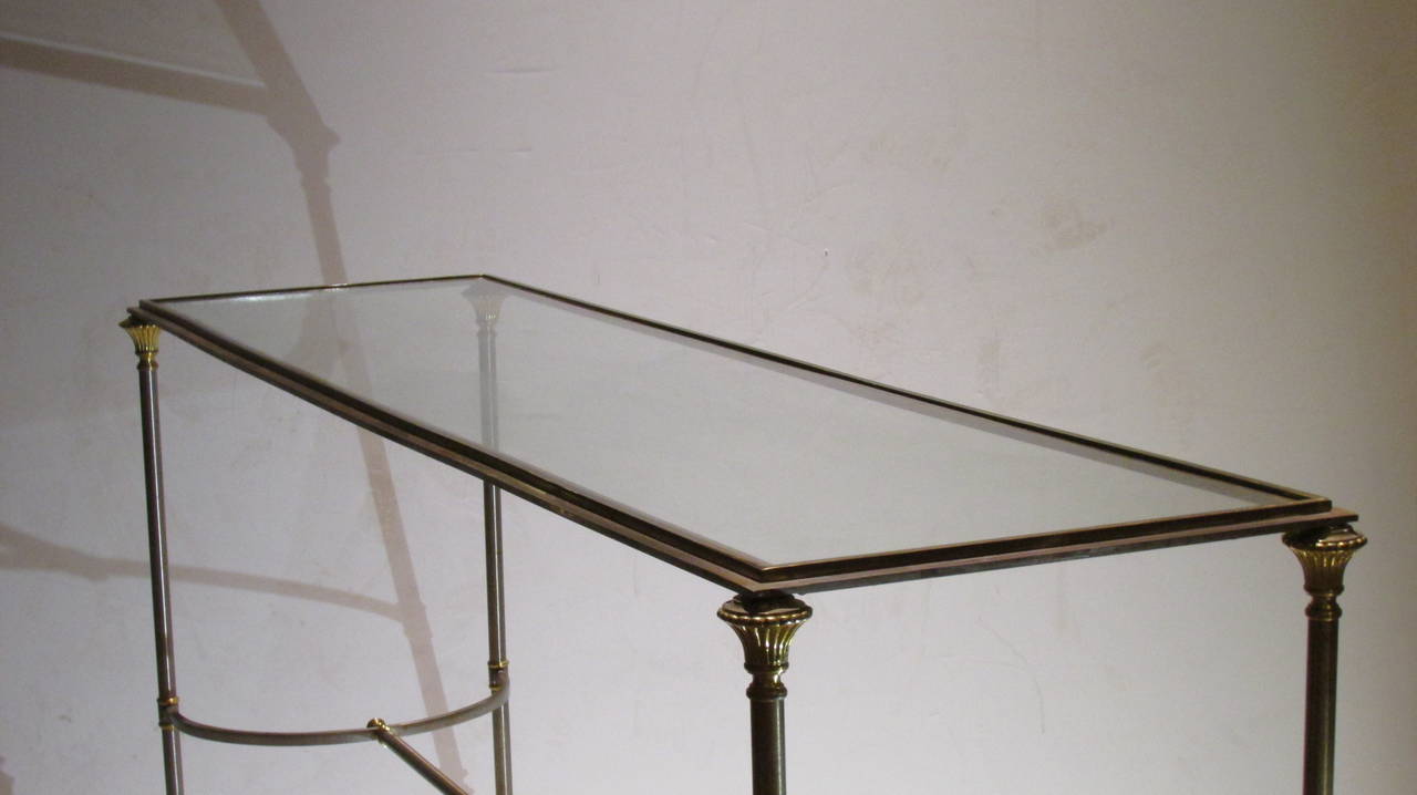 An exceptional quality steel and brass 1960s neoclassical console table in the style of Maison Jansen.