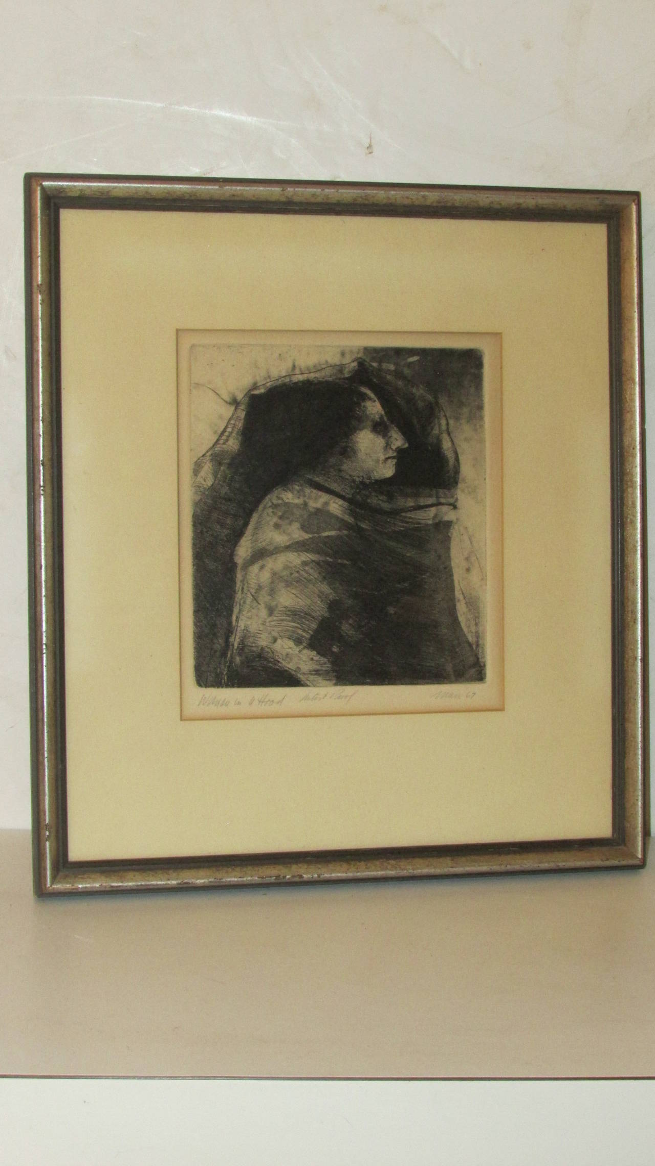 Pencil signed artist proof - titled - Woman in a Hood - 1967 by Robert Marx -  important American figurative & social protest artist associated along with the likes of Leonard Baskin & Leon Golub. Matted in silver gilded wood frame under glass.