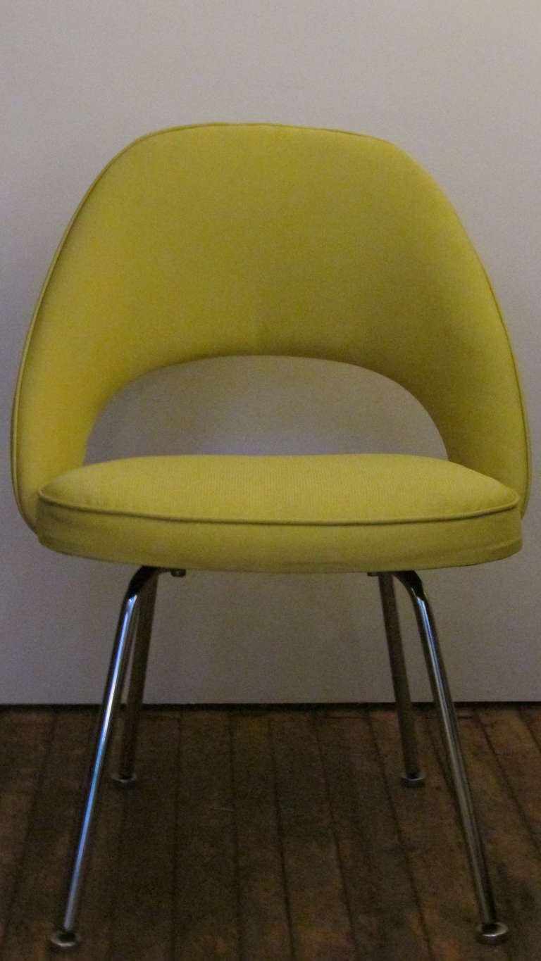 A set of four 1960's Eero Saarinen Executive armless side chairs for Knoll International - all newly reupholstered in a pale saffron Knoll fabric & foam fill.
