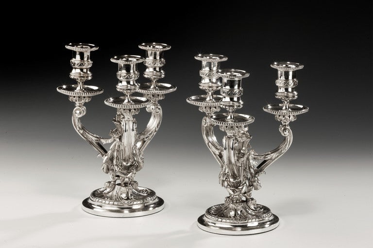 A fine pair of silvered table candelabr in the 18th century style of Jean-Charles Delafosse; a similar pair in the Jones collection at the Victoria and Albert Museum, London. 

Literature: (b Paris, 1734; d Paris, 11 Oct 1789). French decorative