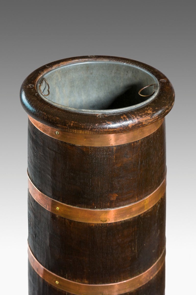 Rare pair of 19th century oak stick or umbrella stands in the form of cannon barrels. Each retaining the original liners. The whole is bound with five copper bands. English circa 1870. 