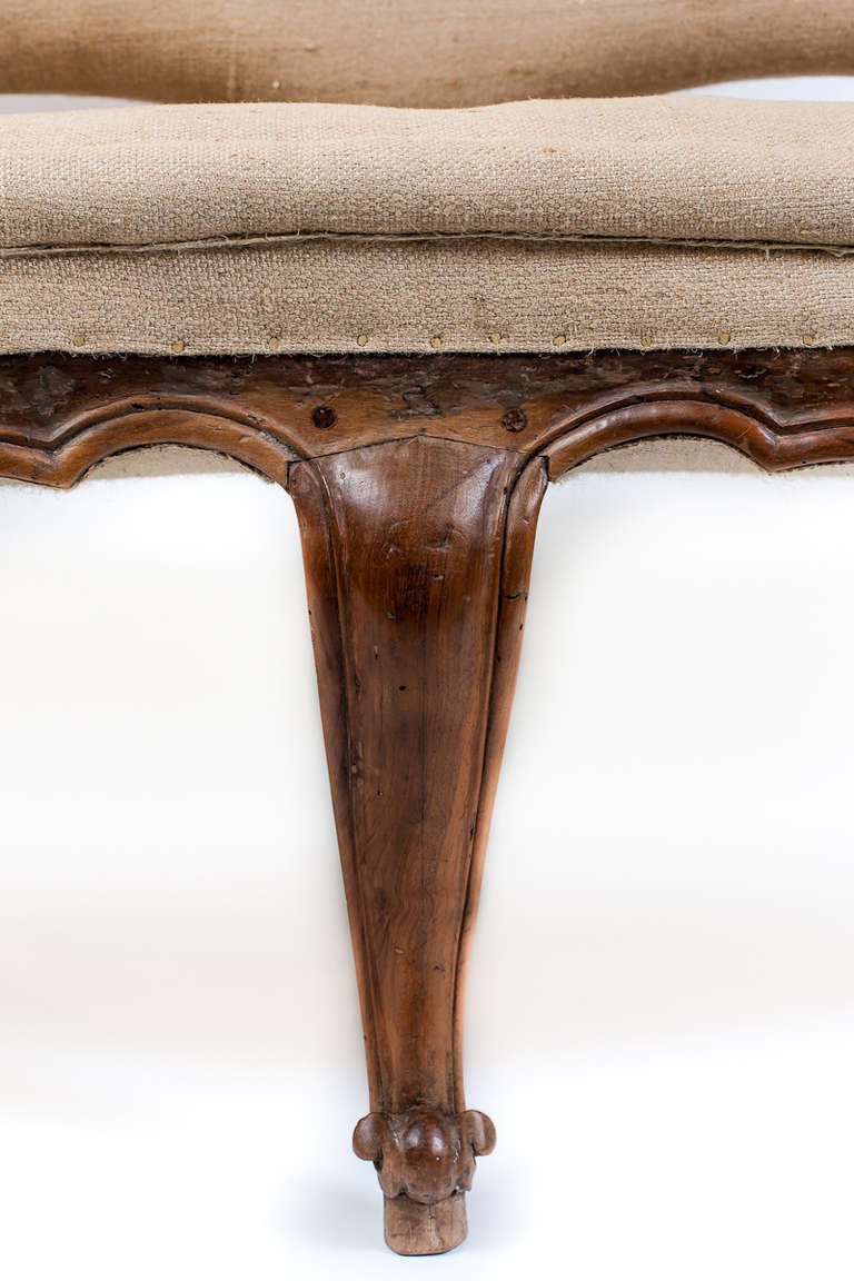 A grand and elegant Italian settee, Raised on eight cabriole legs each with a scrolled toe. The whole was originally decorated. Late 18th - early 19th century; possibly Venetian