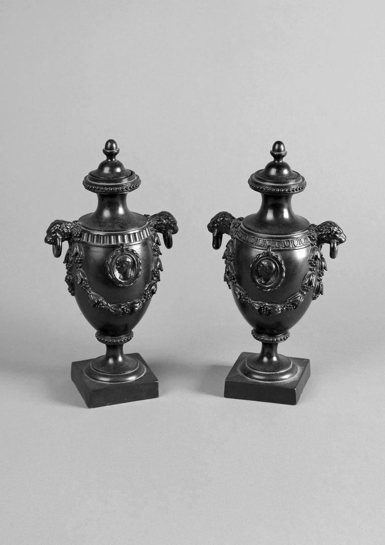 Matched pair of classical black basalt vases with covers in the style of Matthew Boulton. Probably made at the factory of Humphry Palmer or his successor James Neale, Staffordshire.