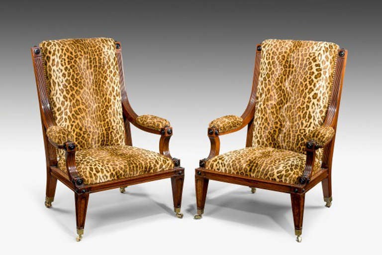 Fine pair of low library arm chairs upholstered in contemporary faux Ocelot fabric.