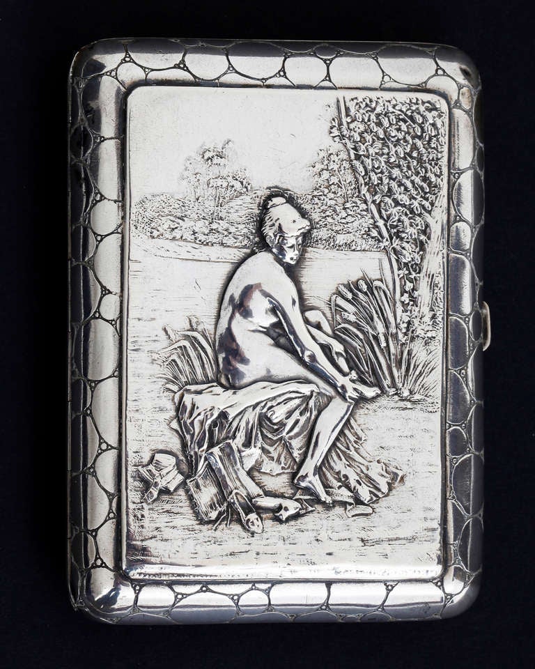 A Continental silver cigarette case of 'The Bather', the cover embossed with a nude female bather seated amongst bullrushes. Marked 800. 

Europe.