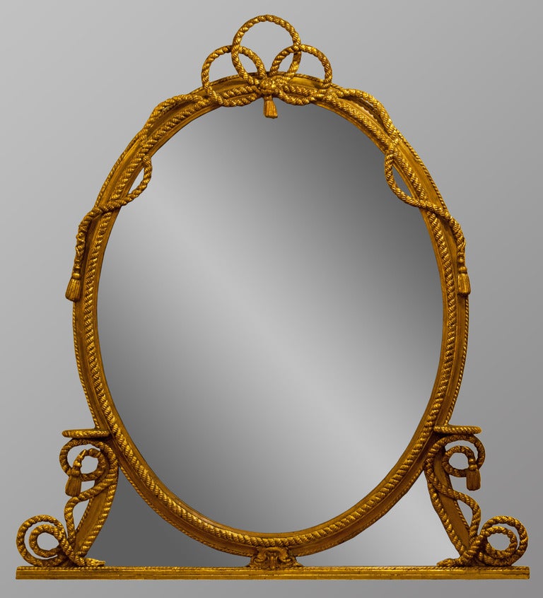 An exceptionally decorative gilt oval Mid 19th Century overmantle mirror with rope decoration. 