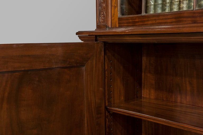 A spectacular quality mahogany cabinet bookcase with ornate and finely carved frieze to the cornice. Circa 1880
