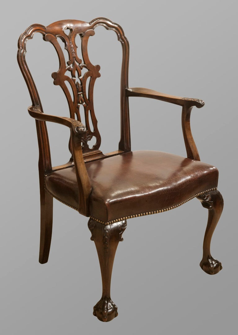A set of six superior quality George II style mahogany dining chairs crisply carved with ball and claw feet. Re-upholstered in antique leather. Circa 1870