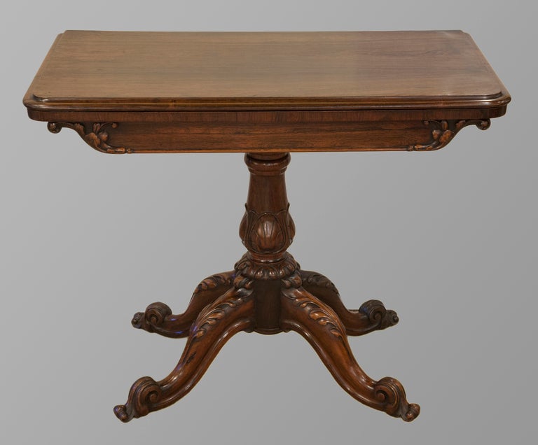 A very fine pair of 19th Century rosewood card tables of excellent colour and condition, the folding swivel tops raised on swan neck frames above crisply carved pillars and splay legs. Maker: Samuel Clark of London. Circa 1855