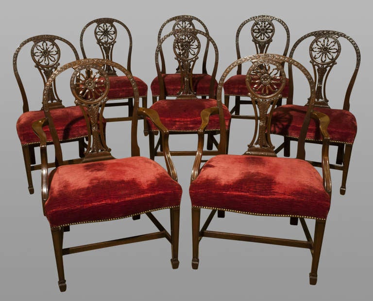 Set of eight Hepplewhite style carved wheel-back dining chairs, comprising of six singles and two armchairs.