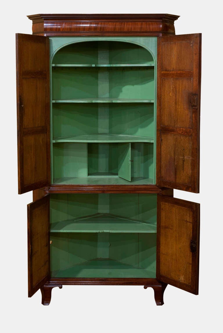 A superb George III mahogany standing corner cupboard with 8 curl and feather veneered panels

Circa 1790