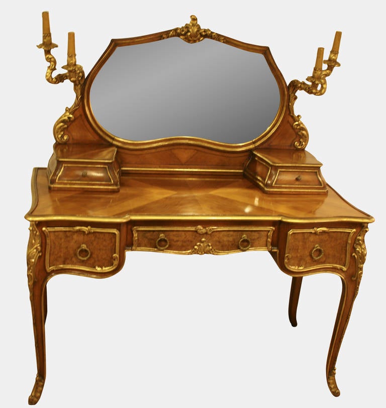 A late 19th Century walnut, burr walnut & parcel gilt French Louis XV style dressing table

Circa 1890