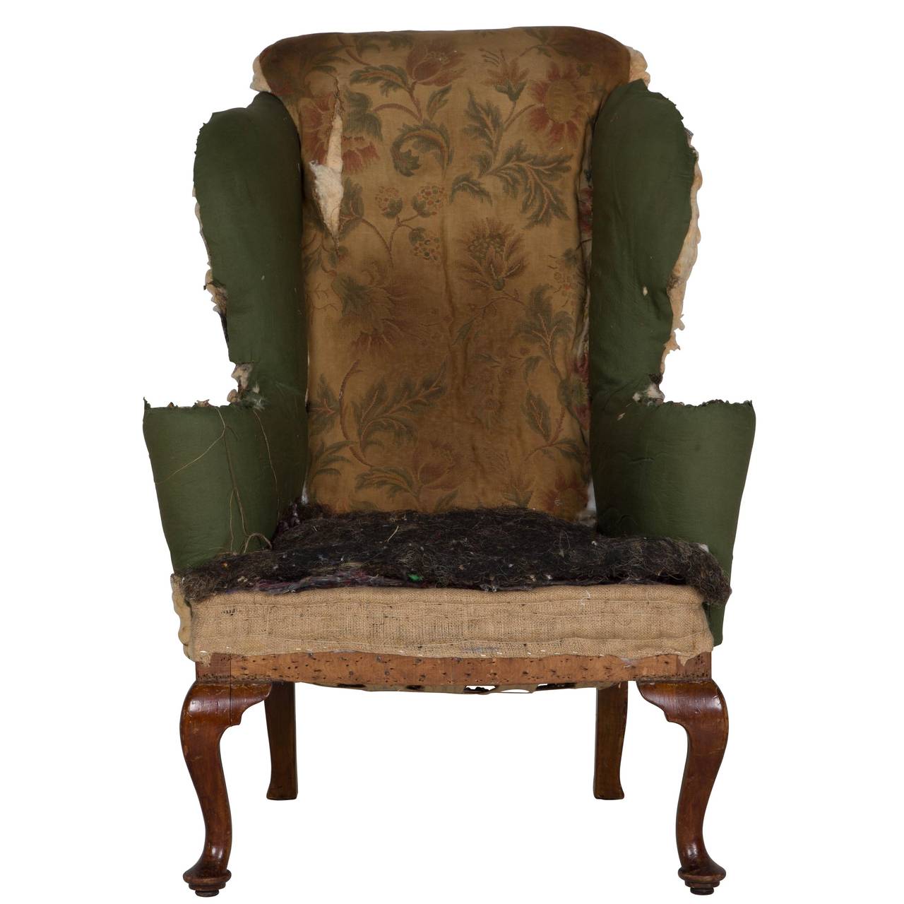 A late 19th century mahogany cabriole leg wing armchair by Howard & Sons (to be upholstered).