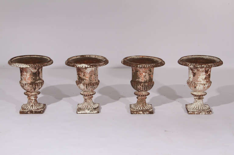 Set of four 19th Century French painted iron urns.