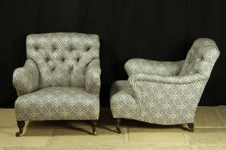 An exceptional pair of Howard & Sons open `Bridgewater` armchairs c.1900 - recovered in a copy of the original Howard & Sons ticking. Possibly the most comfortable chair ever made?!