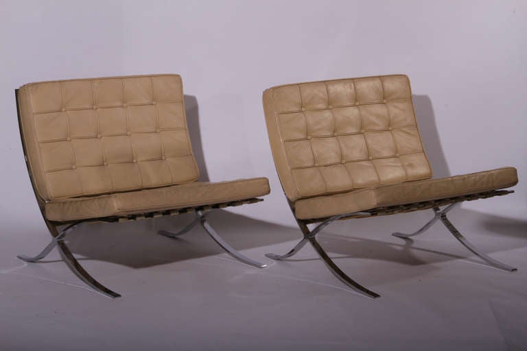 Pair of Barcelona chairs c.1950, with steel frame and original leather cushions (individually stitched and piped pieces) sitting on leather straps. Mid century modern elegance!