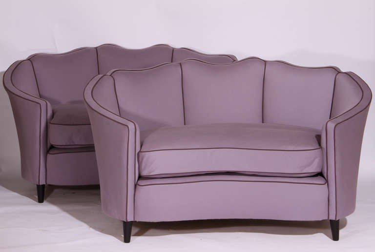 Pair of 1970's corbeille sofas with scalloped back - re-covered in lavender denim with contrast piping - a curvaceous pair!