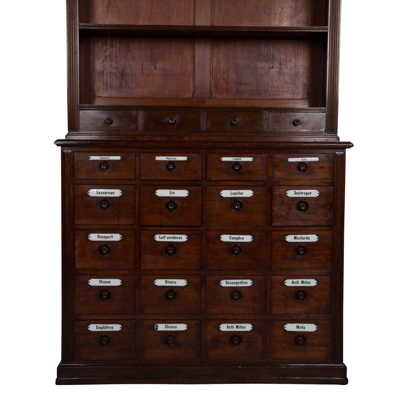 A mahogany pharmacy cabinet with open shelves and drawers below retaining their original enamelled labels, French c. 1890.