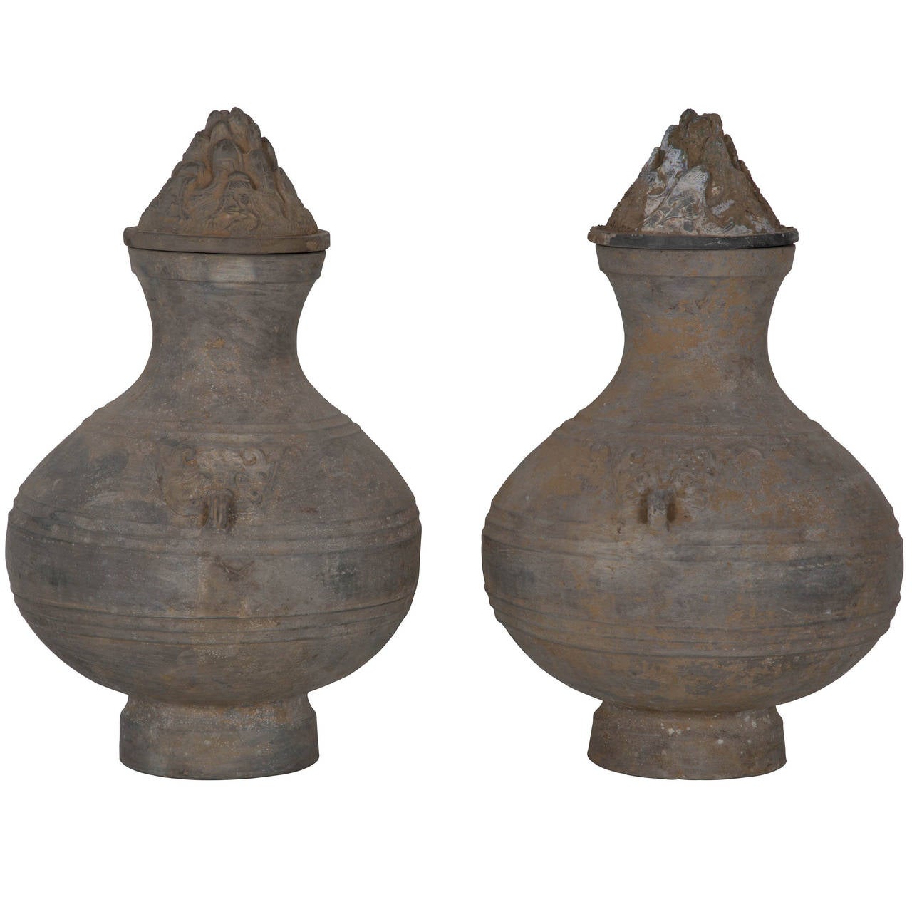 An exquisite and rare pair of 2000 year old Han Dynasty urns with separate decoratively detailed conical lids. £1,160 each.