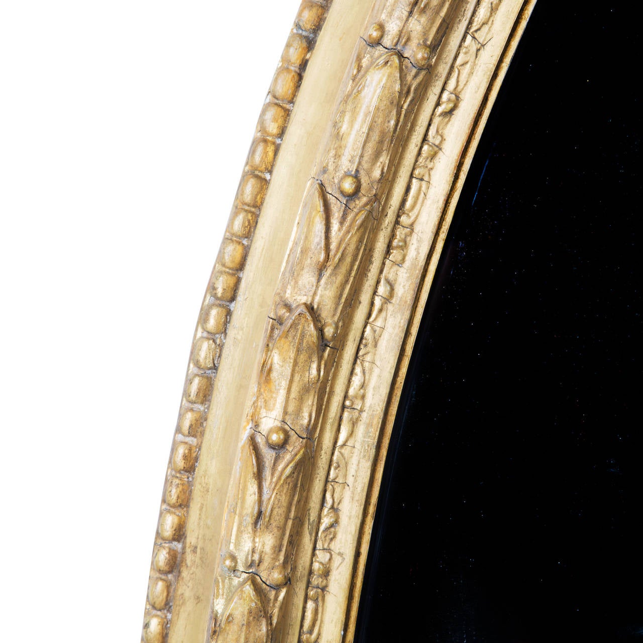 A fine and rare Regency period large oval gilt mirror with its original mercury glass plate, English c. 1820.