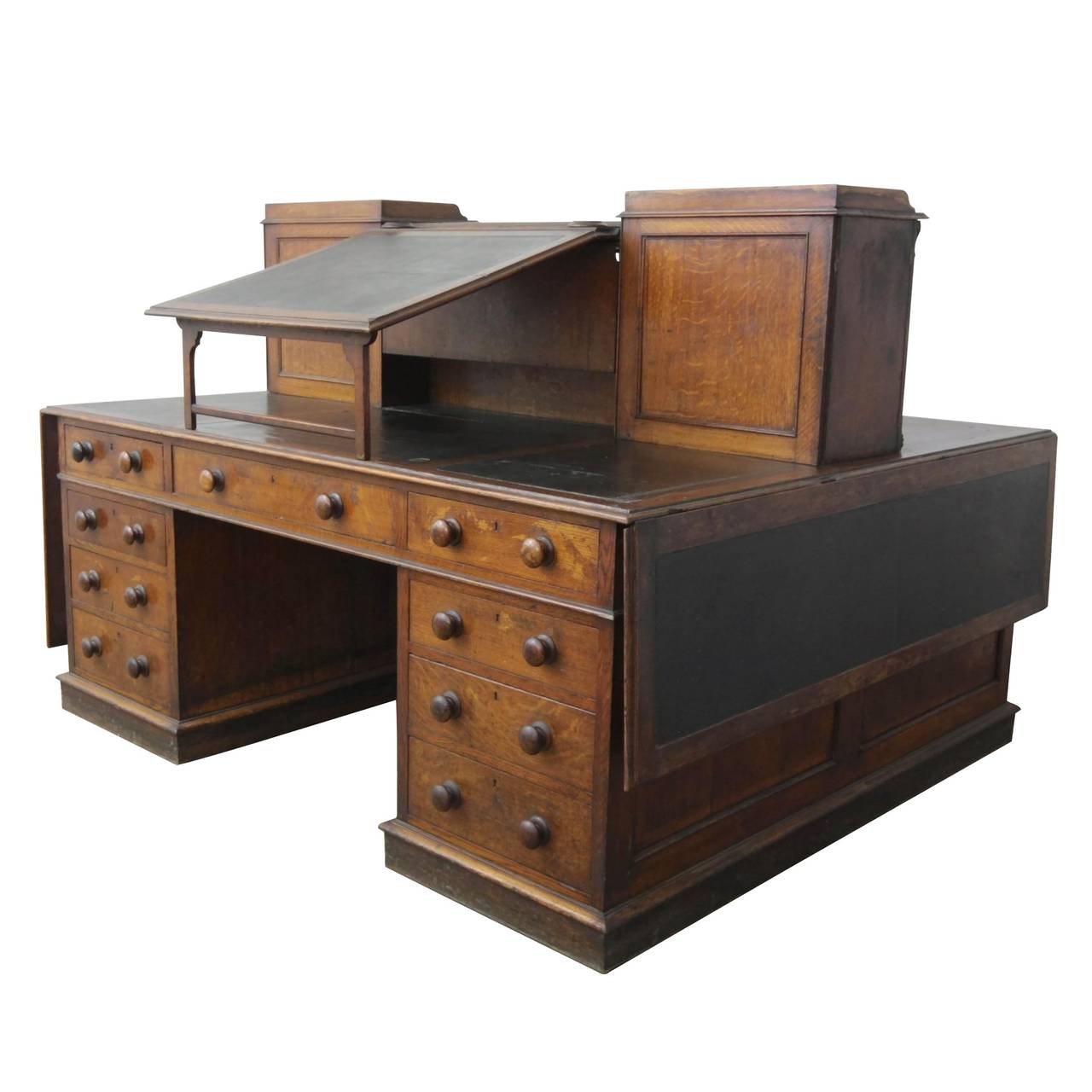 A large and fantastic oak 'Dickens' partners desk, attributed to Gillows. England c.1850 Width extends to 2m 80cm when folding leaves are raised. One of these leaves has been reduced at some time in the pas.
