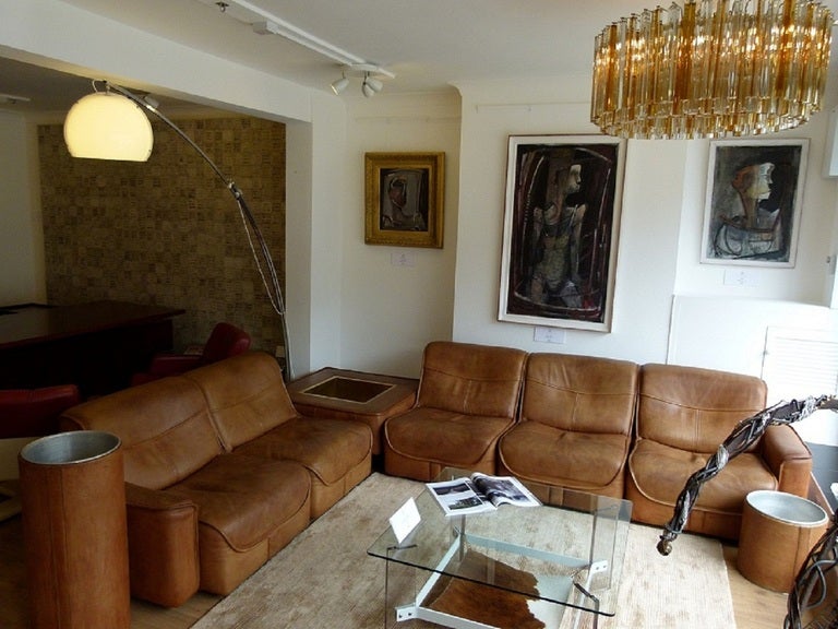 A very rare early design from de Sede Switzerland
This Buffalo Hide modular sofa dates from c.1972
The suite consists of five seats, two of which have arms, a brass lined corner section which doubles as a coffee table/planter/ice bucket and a