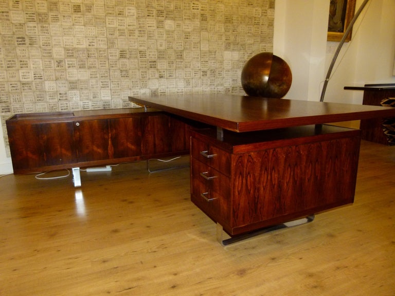 A stunning vintage executive desk by E.Pedersen & Son, Denmark.
This desk is one of a matching pair of executive desks commissioned by the executives of Pinewood film studios in 1965, during the making of the James Bond film Thunderbal. We also