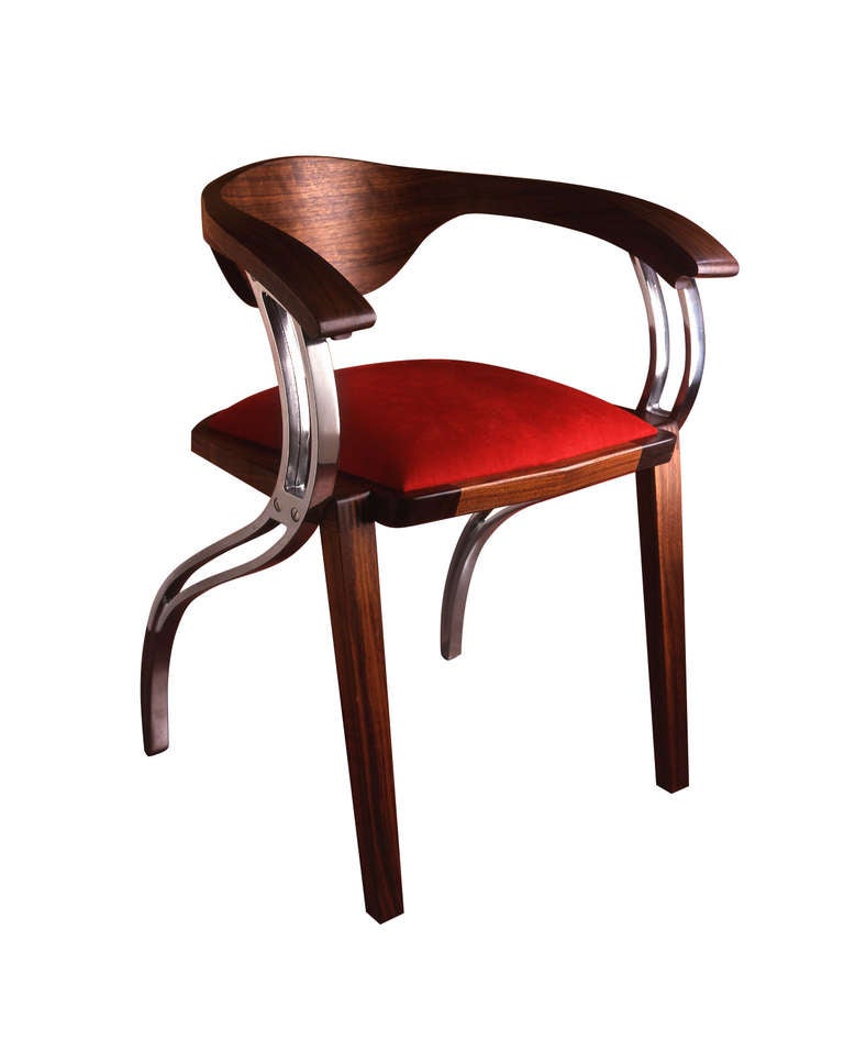 A striking design from the British Designer Sebastian Blakeley.

Described recently as the 'Alfa Romeo' of dining chairs.

This piece titled Parlare, which translates as the talking chair, combines American Black Walnut with polished Aluminium.