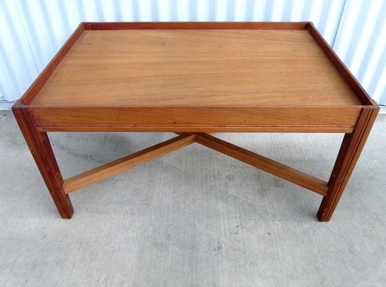 Sleek and Chic Vintage Mid Century Modern Teak Table having tray style top above X stretcher base joining tapered legs. Understated, elegant, beautifully made, an excellent rendition of the classic butler's table with a pared down Danish mid century