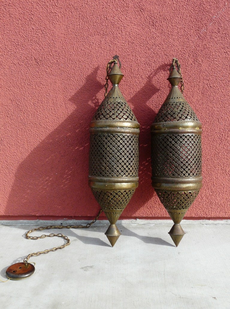 Wonderful Pair large scale Moroccan Brass Lanterns having long, attractive pierced forms and excellent vintage patina. In great working condition.