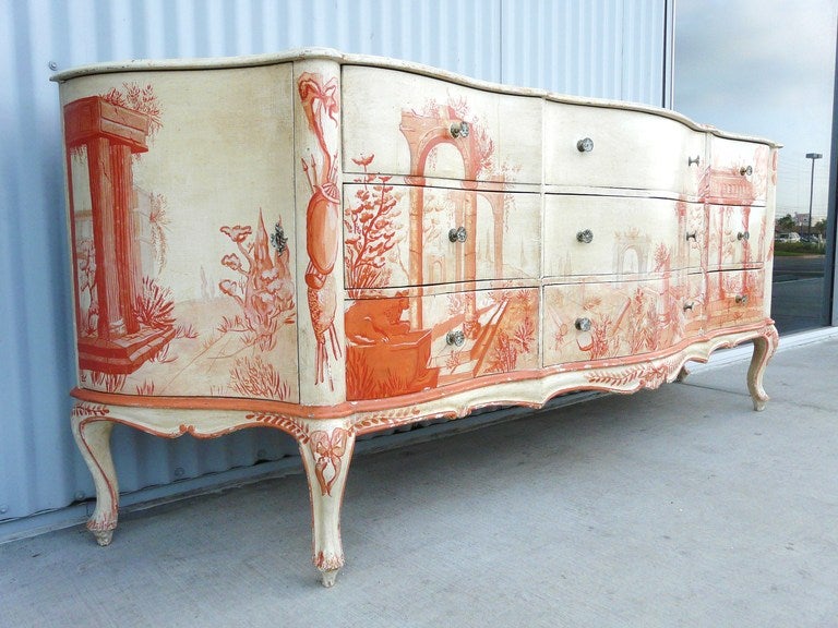 Fabulous vintage paint decorated Chest of Drawers having serpentine front rising atop cabriole legs and faux marble top. This lovely dresser has exquisite garden and pavilion scenes hand painted in shades of carnelian against a cream field, and has