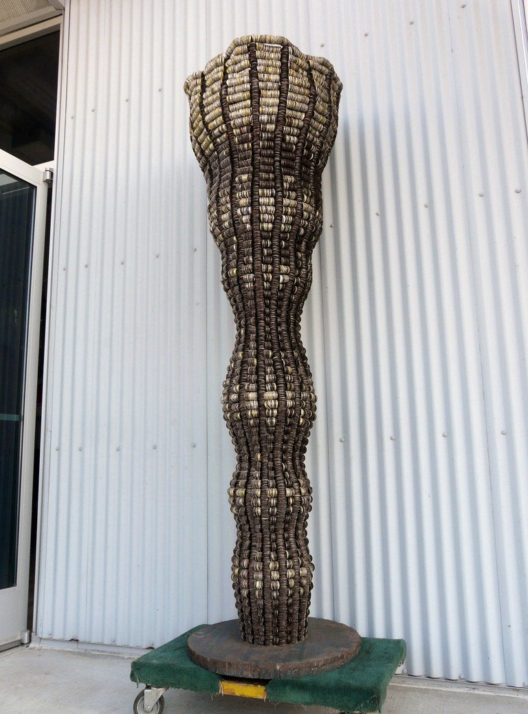 Exceptional sculpture by Clare Graham made from bottle caps, imposing in size and visial impact. Industrial and graphic yet fluid on the whole. Wonderful. 

85