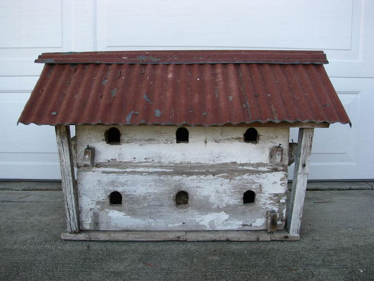 Exceptional and large antique dovecote having weathered paint finsih and barn red corrugated metal roof. 