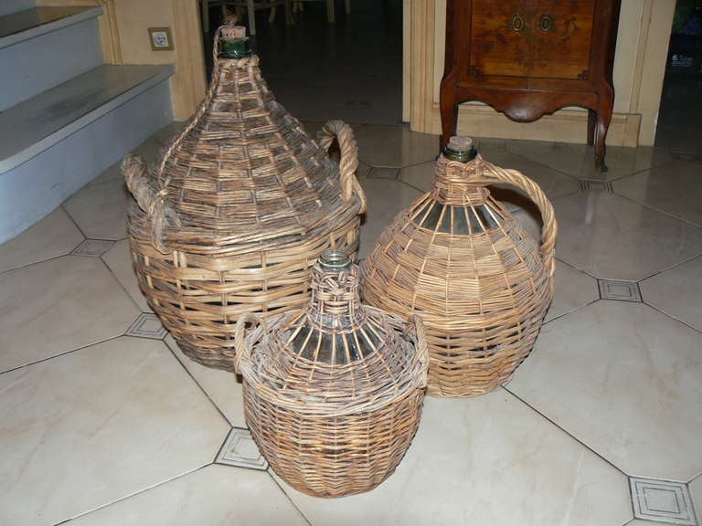 Lovely group of antique French bonbonnieres - wine jugs in handwoven split reed and reed wicker-  from Provence, aka ancienne bonbonne Dame Jeanne, largest standing 55 cm tall.